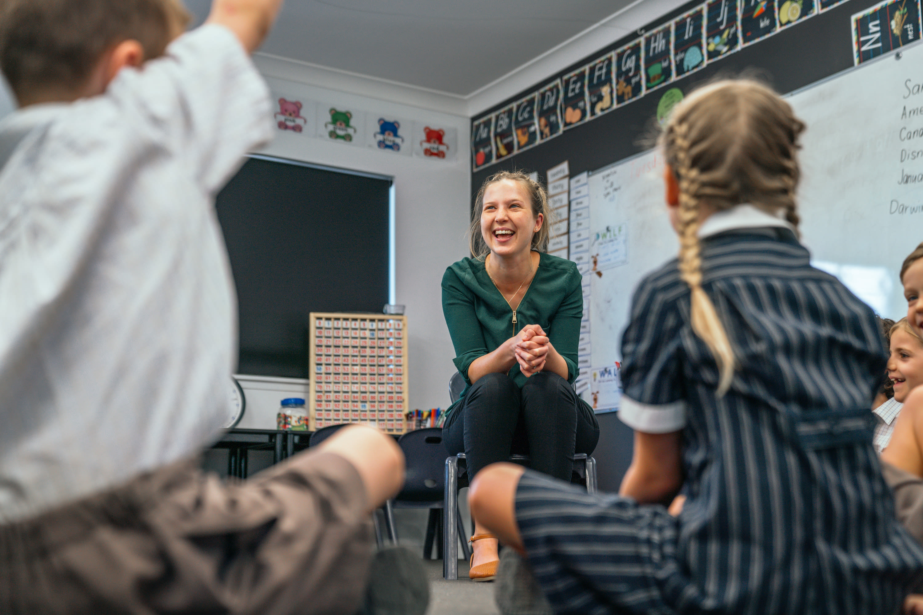 Student raising hand in classroom