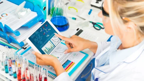 Woman in a lab using a tablet