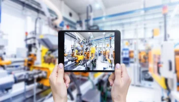 A person taking a image on a tablet in a factory.