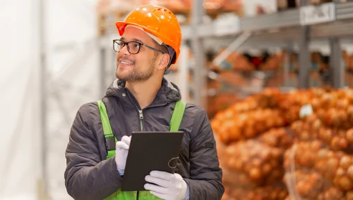 Worker in warehouse inputting data in a tablet
