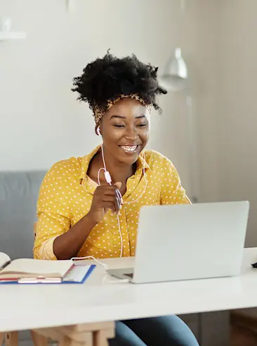 Woman smiling working on her laptop.