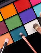 A colorful makeup palette and brushes