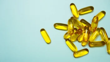 Omega-3 fish oil capsules on a blue background
