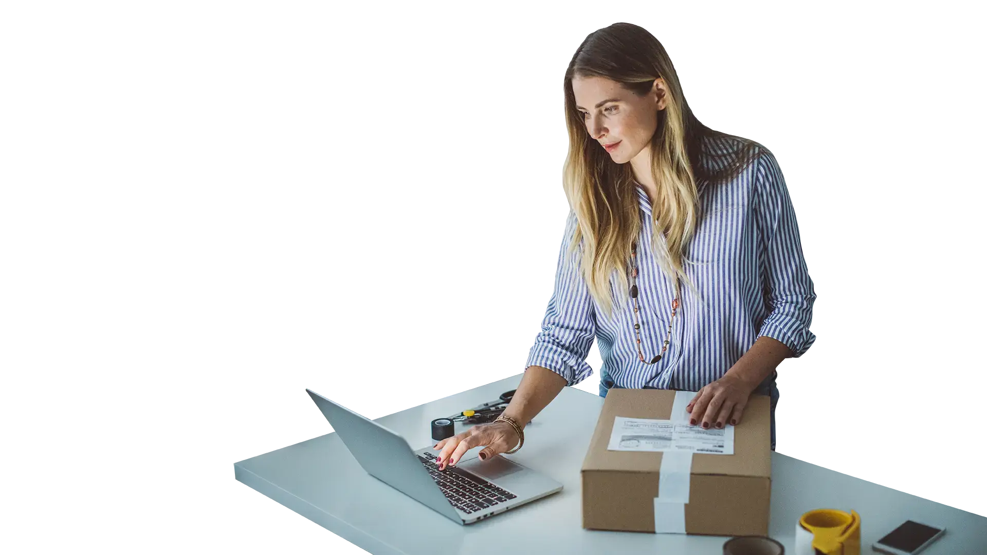 Woman working on laptop at shipping desk