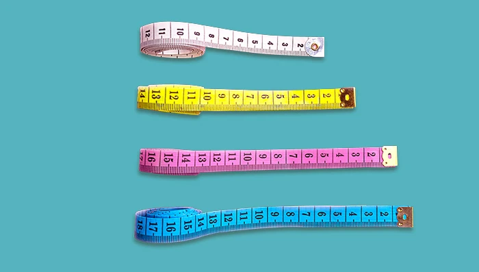 Colorful tape measures stacked in line