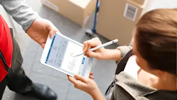 Delivery guy receiving signature from woman. Proof of delivery.