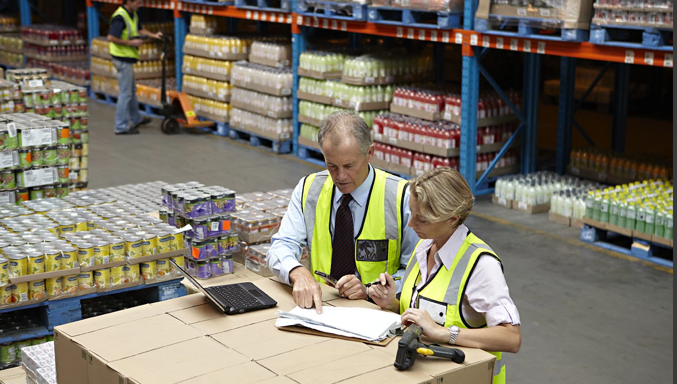 Warehouse workers reviewing inventory