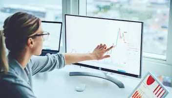 woman pointing at computer screen