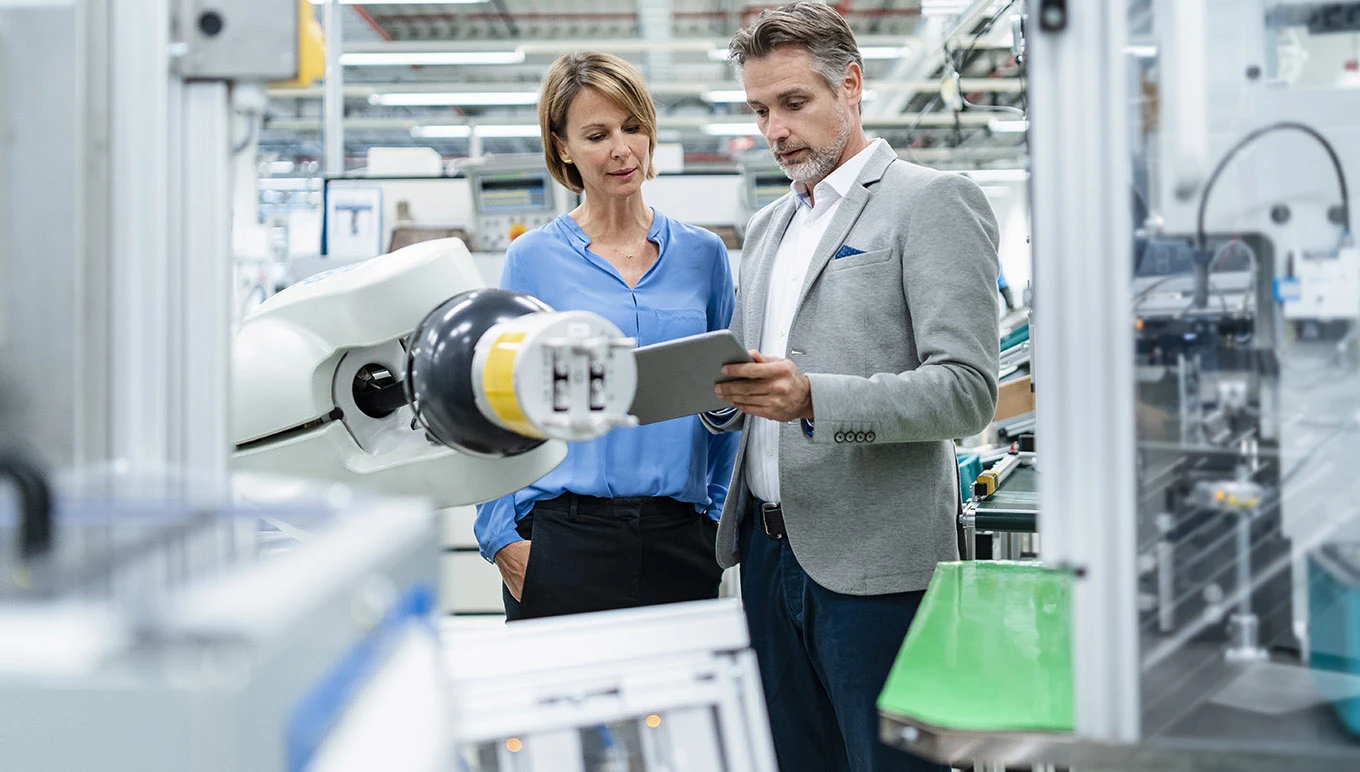 business people checking robot hand