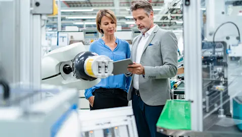 business people checking robot hand