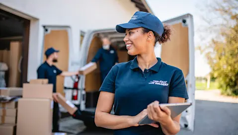 Delivery team with packages from delivery van