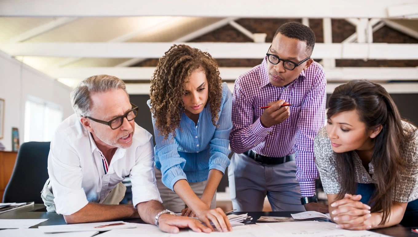 Business leaders gather around to discuss the various types of ERP systems.