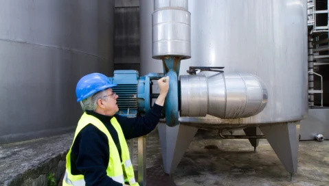 Maintenance worker examining machinery