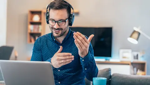Man sitting in front of his computer for an online meeting.