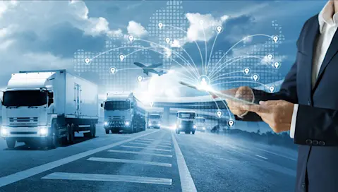 Trucks on the highway next to person with virtual tablet