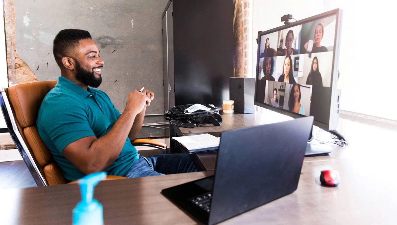 Man at desk on virtual call