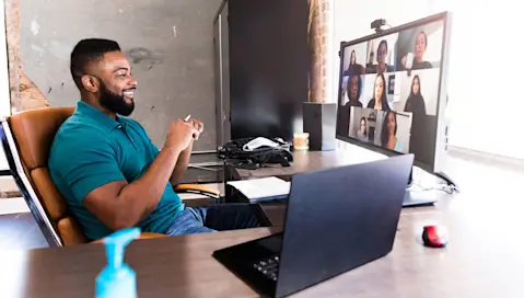 Man at desk on virtual call