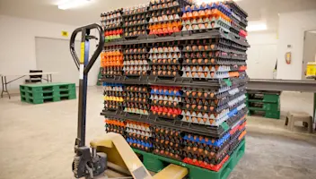 Egg crates stacks on lift in warehouse