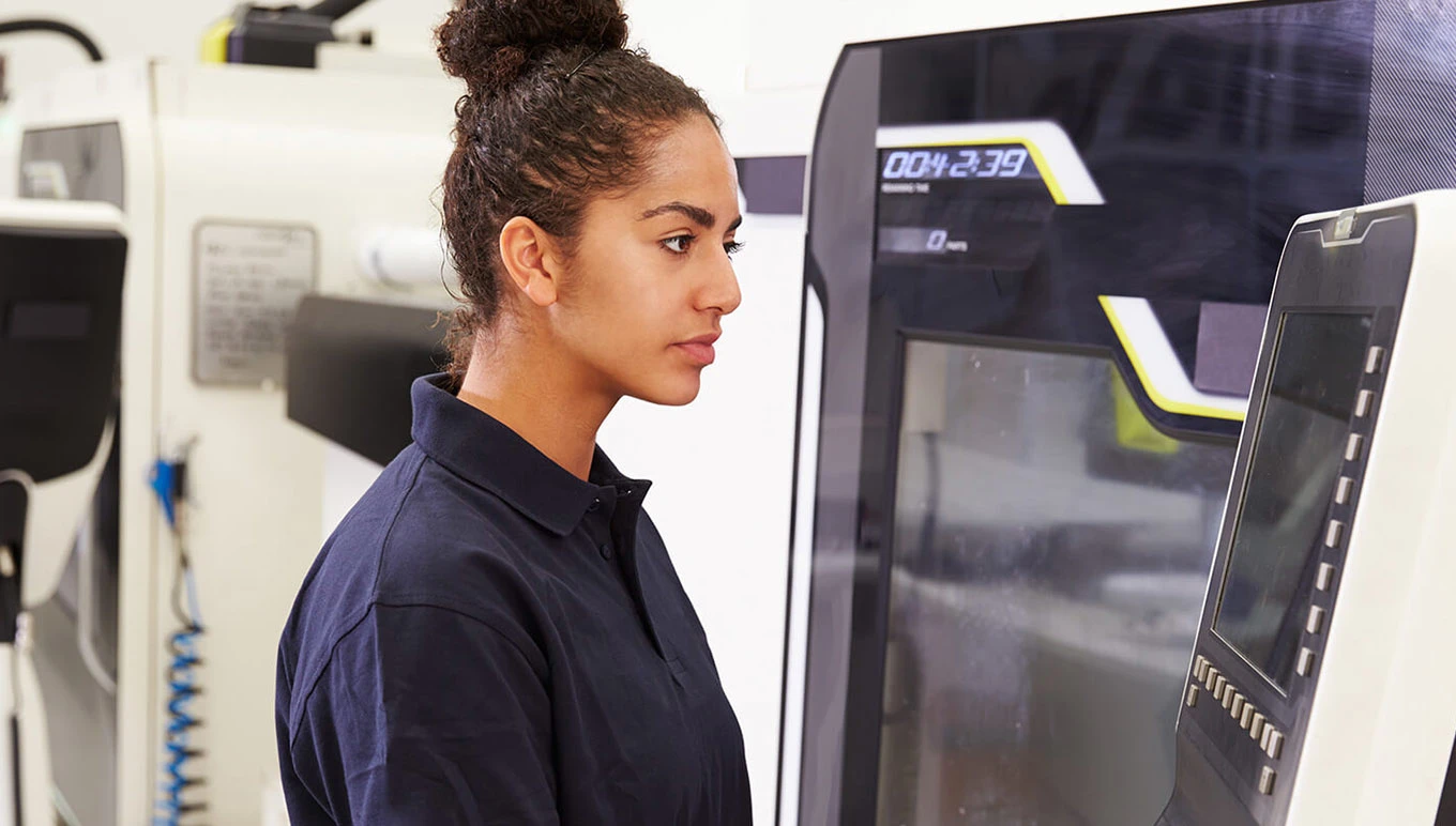 Woman with electronic equipment in factory