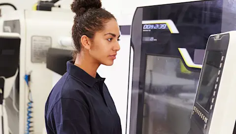 Woman with electronic equipment in factory