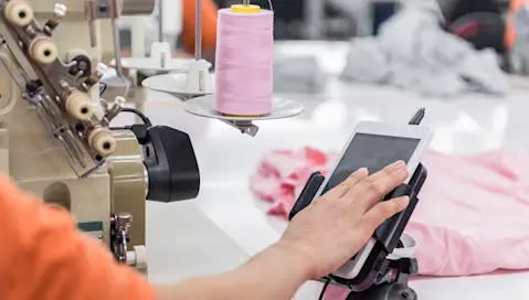 Person using a tablet in production line