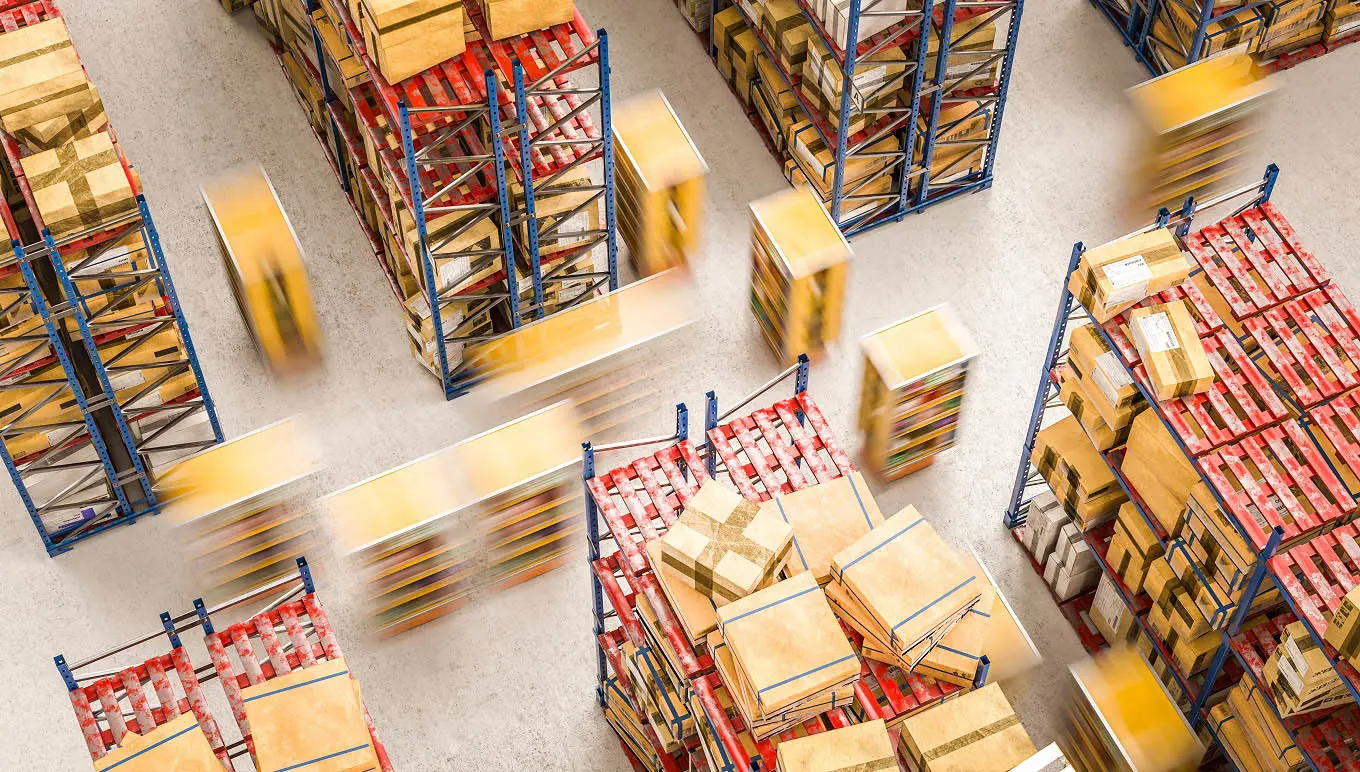 Warehouse workers in action moving boxes