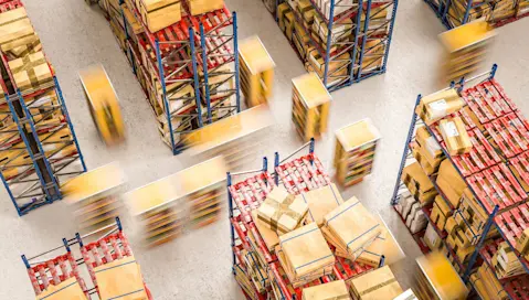 Warehouse workers in action moving boxes