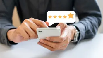 Person leaving a review on his cellphone.