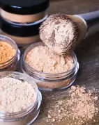 A powder brush and loose powder makeup discs