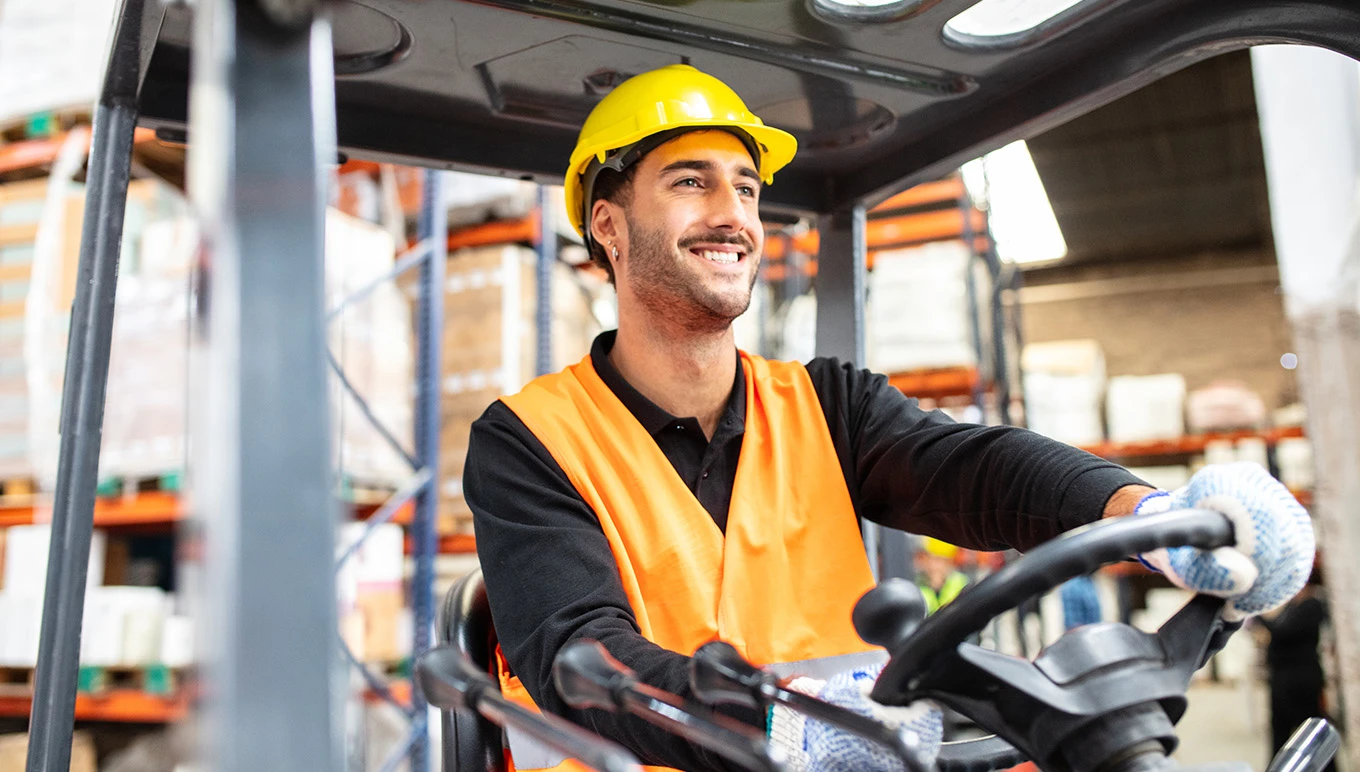 Equipment operator driving in warehouse