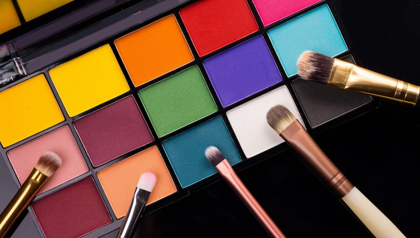 A colorful makeup palette and brushes.