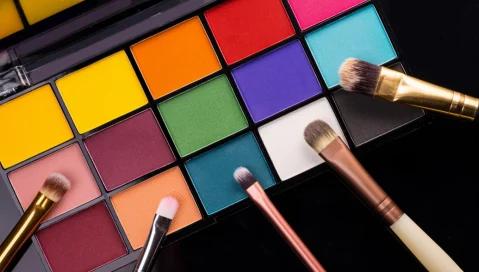 A colorful makeup palette and brushes.