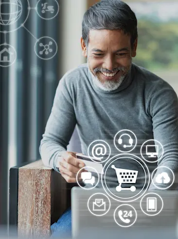 Man holding credit card making purchase on laptop.