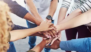 Hands piled together in a circle