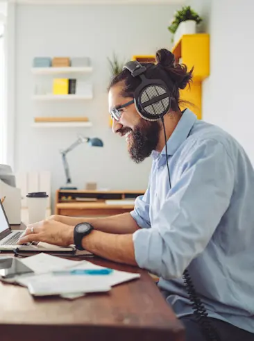 Man typing on laptop while sitting at desk