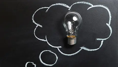 A lightbulb in a thought bubble representing a new idea.