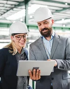 Man and woman looking at laptop in factory