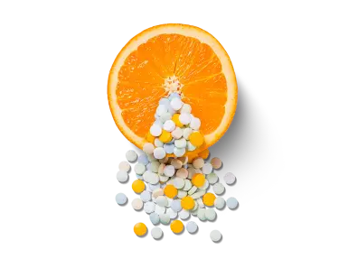 Vitamin C pills and a citrus fruit