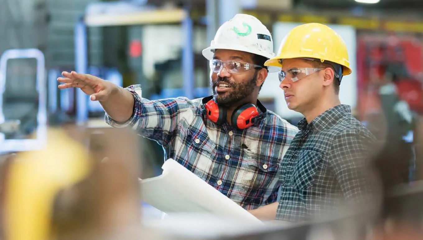 two discrete manufacturing workers conversing