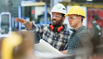 two discrete manufacturing workers conversing