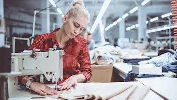 A Woman using a sewing machine