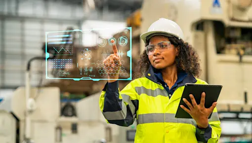 Factory worker with tablet and interacting with virtual screen