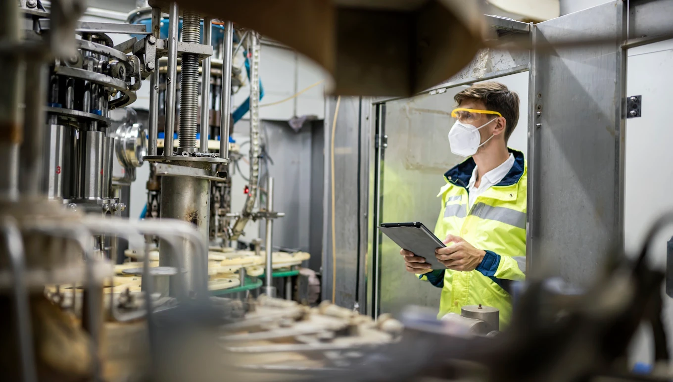 Engineer working at Fruit juice Bottle Automated conveyor belt.