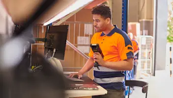 Man standing with scanner in hand.