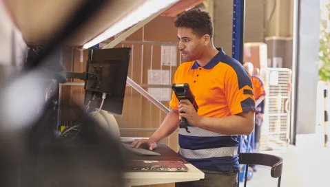 Man standing with scanner in hand.