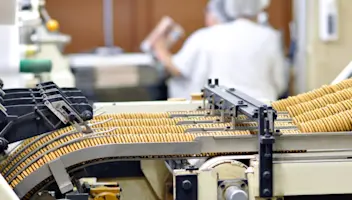 Cookies roll down a conveyer at a contract manufacturing facility.