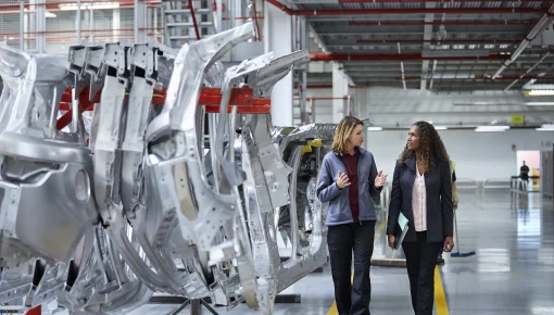 Two women talking in clean manufacturing plant