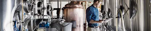 Man on tablet in distillery