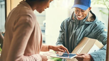 Woman signing a touchscreen for a package delivery