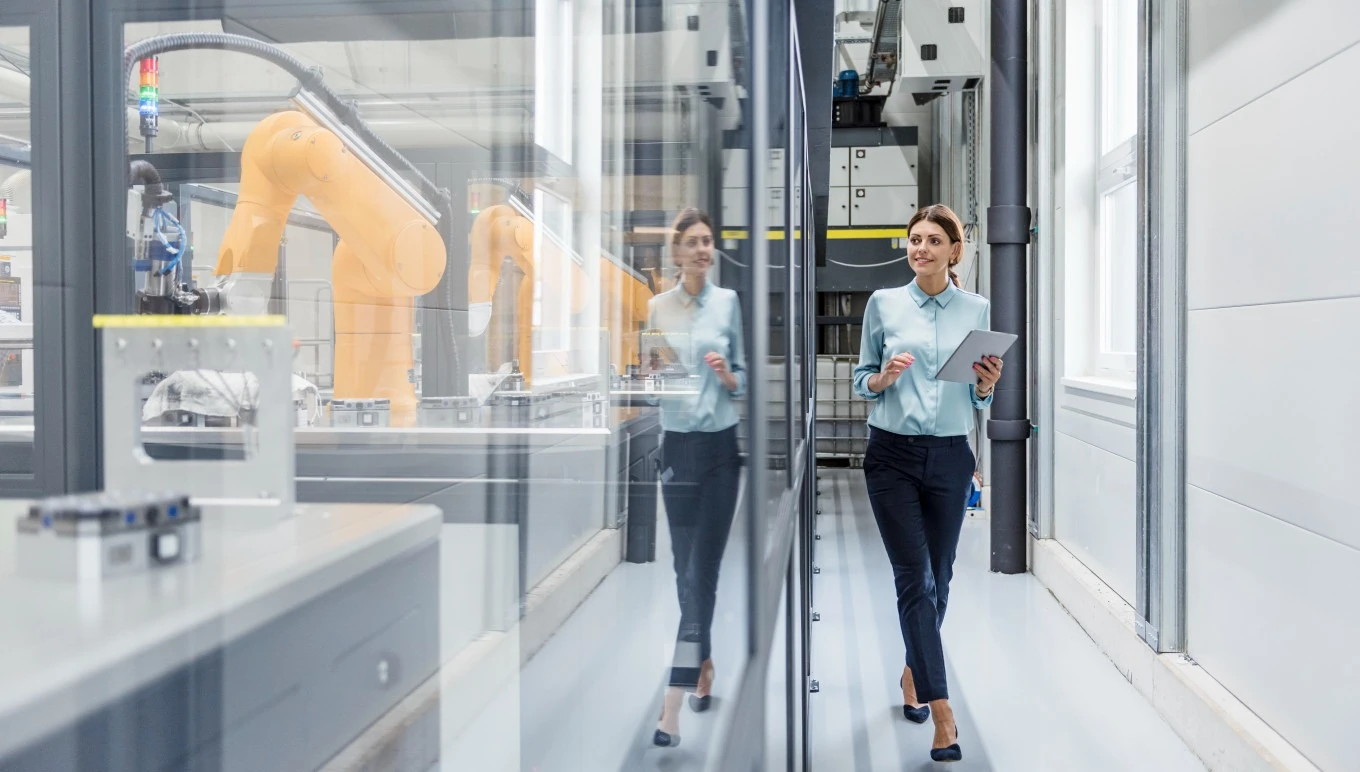 Professional woman walking in manufacturing